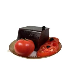 Gros plan sur la pâte de fruit tomate truffe d'été, une confiserie artisanale raffinée alliant la douceur de la tomate et l'arôme unique de la truffe.